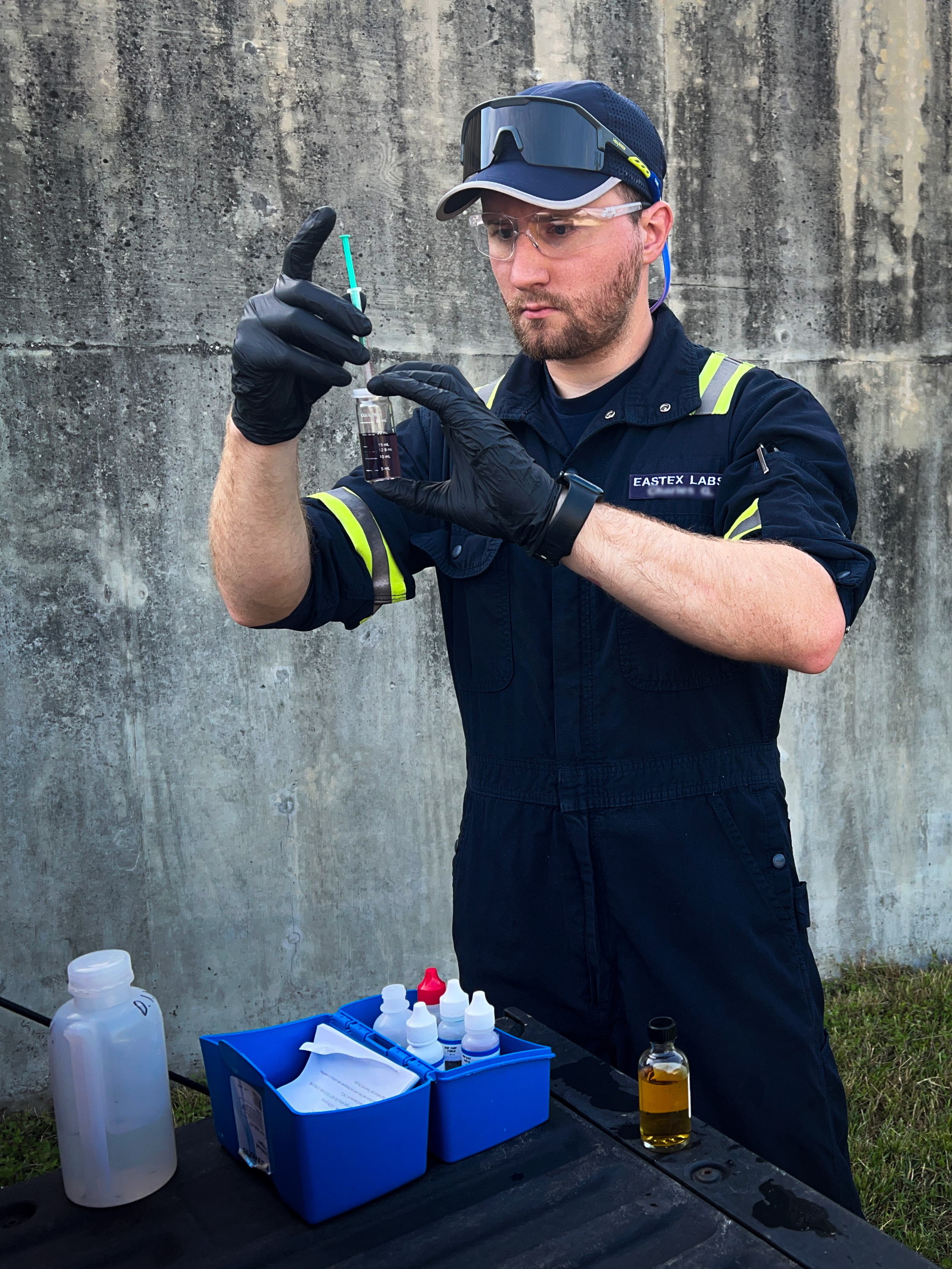 Eastex field technician handling a sample at a treatment facility